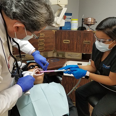 Dentist and team member providing dental care