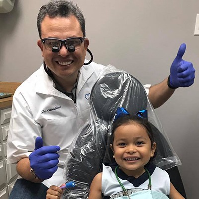 Dr. Caballeros and young patient smiling together