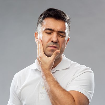 Man in pain holding jaw