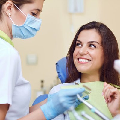 Smiling woman visiting her Carrollton sedation dentist