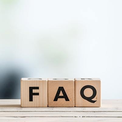 Three wooden blocks spelling out FAQ