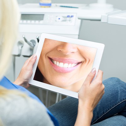 Patient looking at virtual smile design on tablet computer