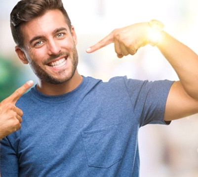 man pointing to his smile